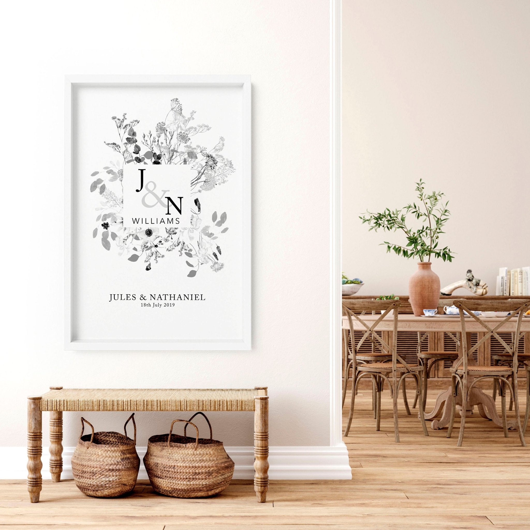 Personalised wedding anniversary wall art print featuring a botanical monogram design in neutral grey, customised with names and anniversary details.