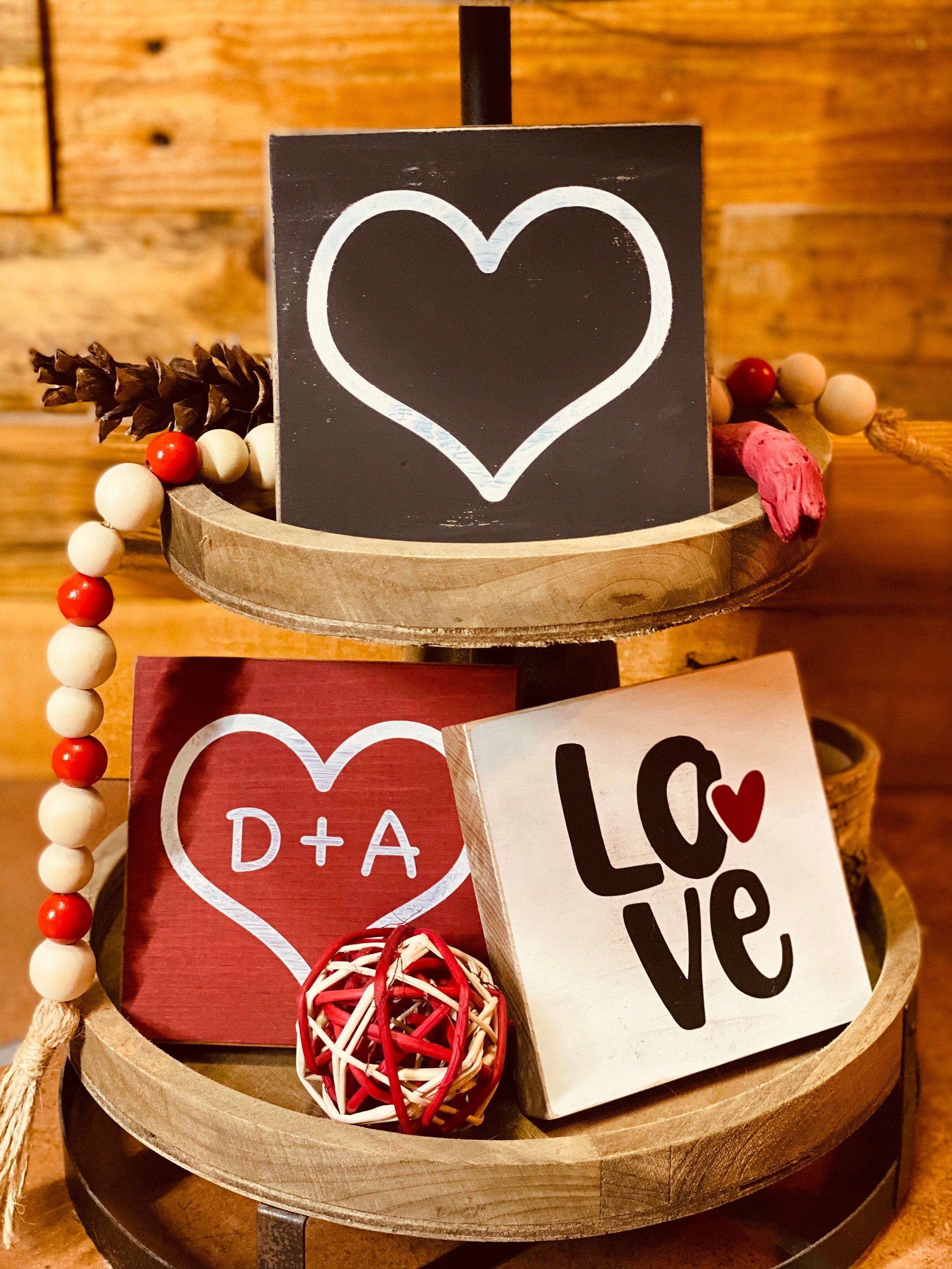 Personalized Valentine's Day Tiered Tray Set featuring hand-painted signs in red, black, and white with heart designs and initials.