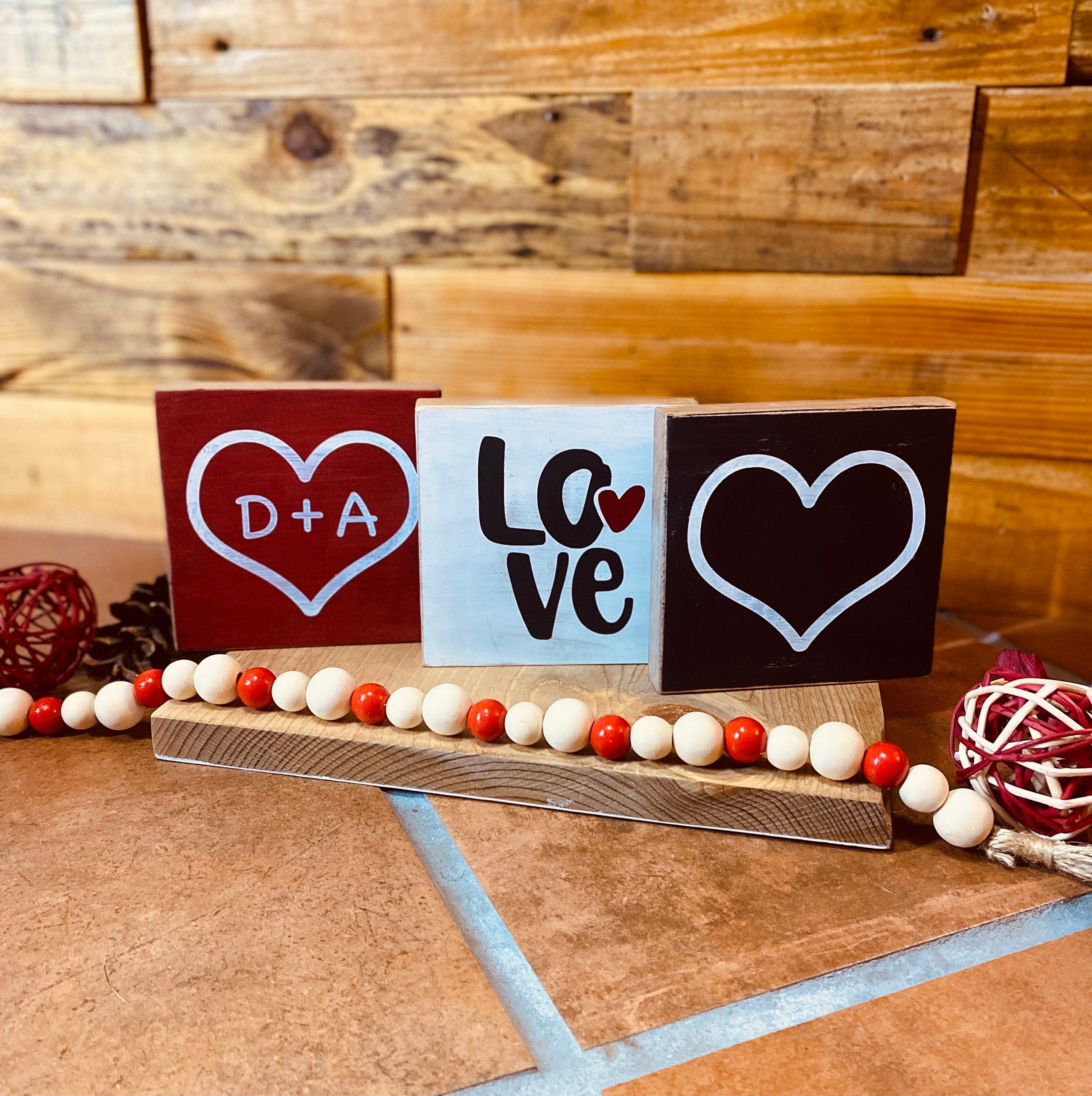 Personalized Valentine's Day Tiered Tray Set featuring hand-painted signs in red, black, and white with heart designs and initials.