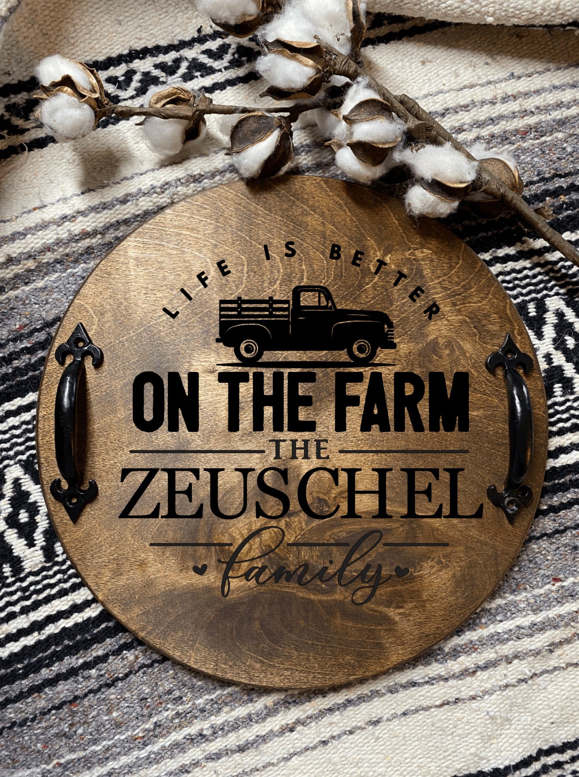 A personalized wooden serving tray with a vintage farm pickup truck design and black metal handles, stained in rich chestnut color.