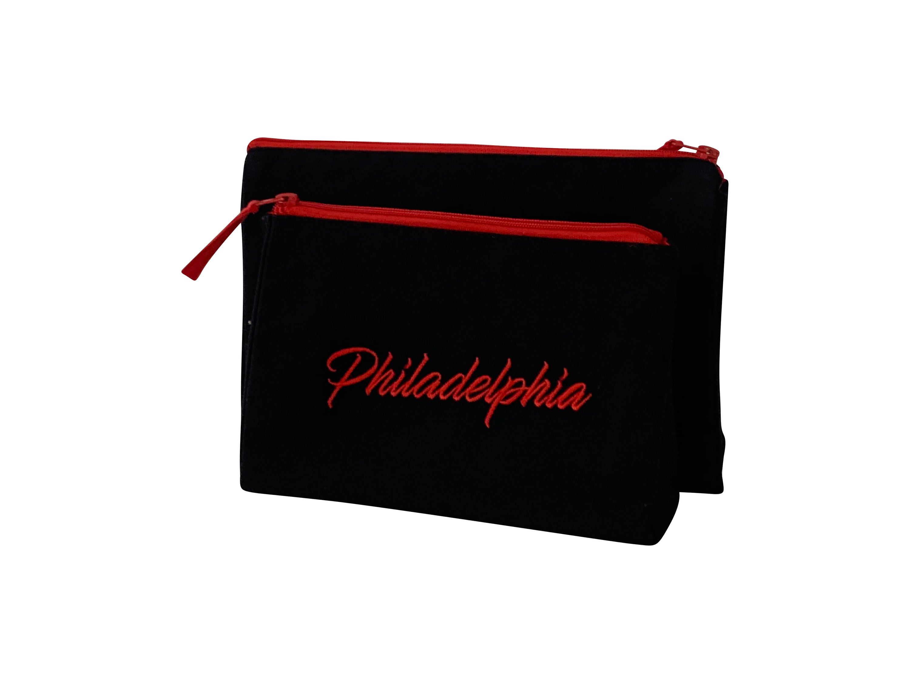 Philadelphia Makeup Bag set featuring embroidered skyline design on cream and black cotton canvas with red waterproof lining.