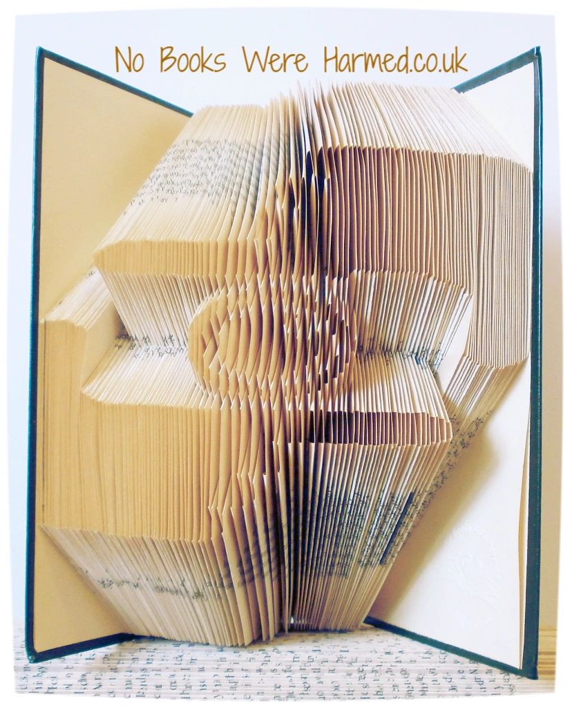 A beautifully crafted piece of book art featuring hand-folded pages from vintage books, showcasing intricate designs and textures.