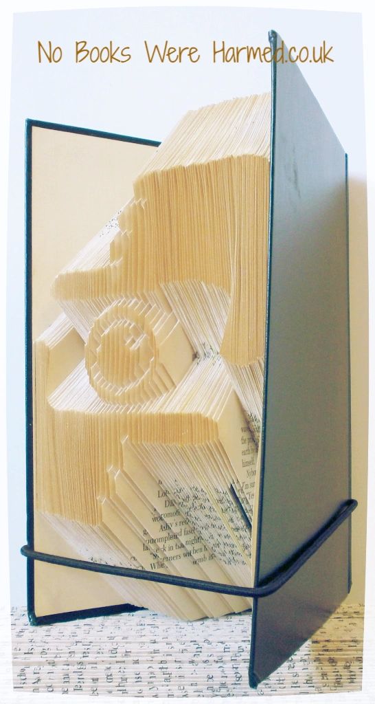 A beautifully crafted piece of book art featuring hand-folded pages from vintage books, showcasing intricate designs and textures.