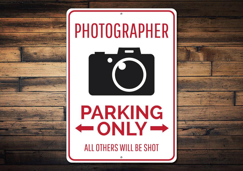 A customizable Photographer Parking Sign made of high-quality aluminum, featuring a unique design suitable for various vehicles.