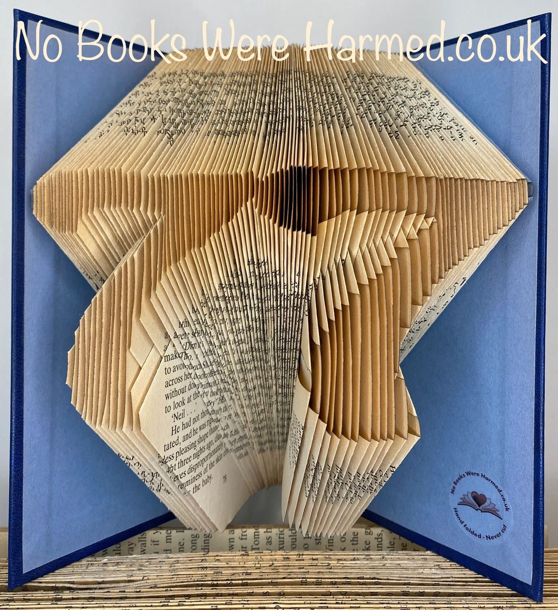 Handcrafted book art featuring a customizable two-digit number, made from vintage pages with intricate folds.