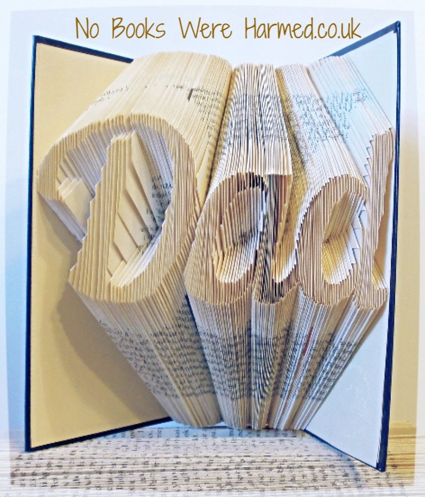 Hand-folded book art displaying custom words and punctuation, showcasing unique designs from vintage books.