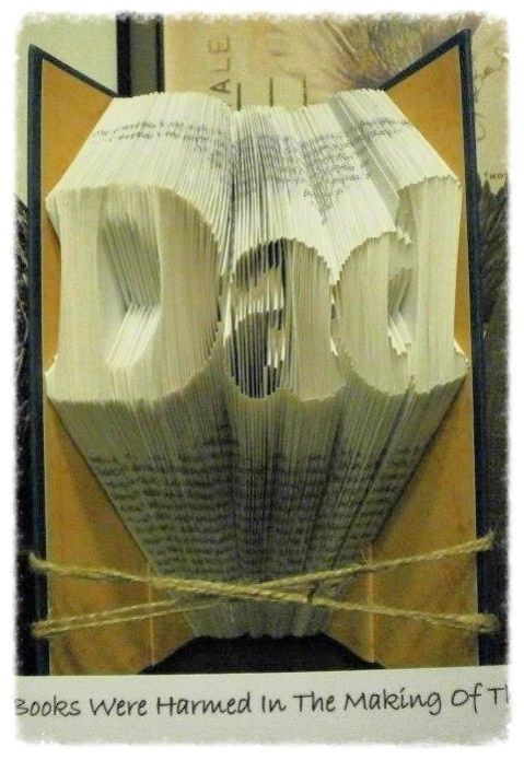 Custom book art featuring hand-folded letters from vintage books, showcasing unique designs and colors.