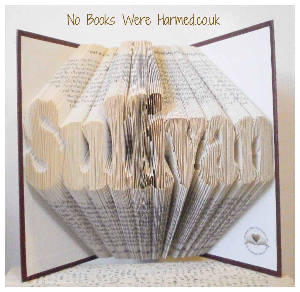 Custom book art featuring hand-folded letters from vintage books, showcasing unique designs and colors.