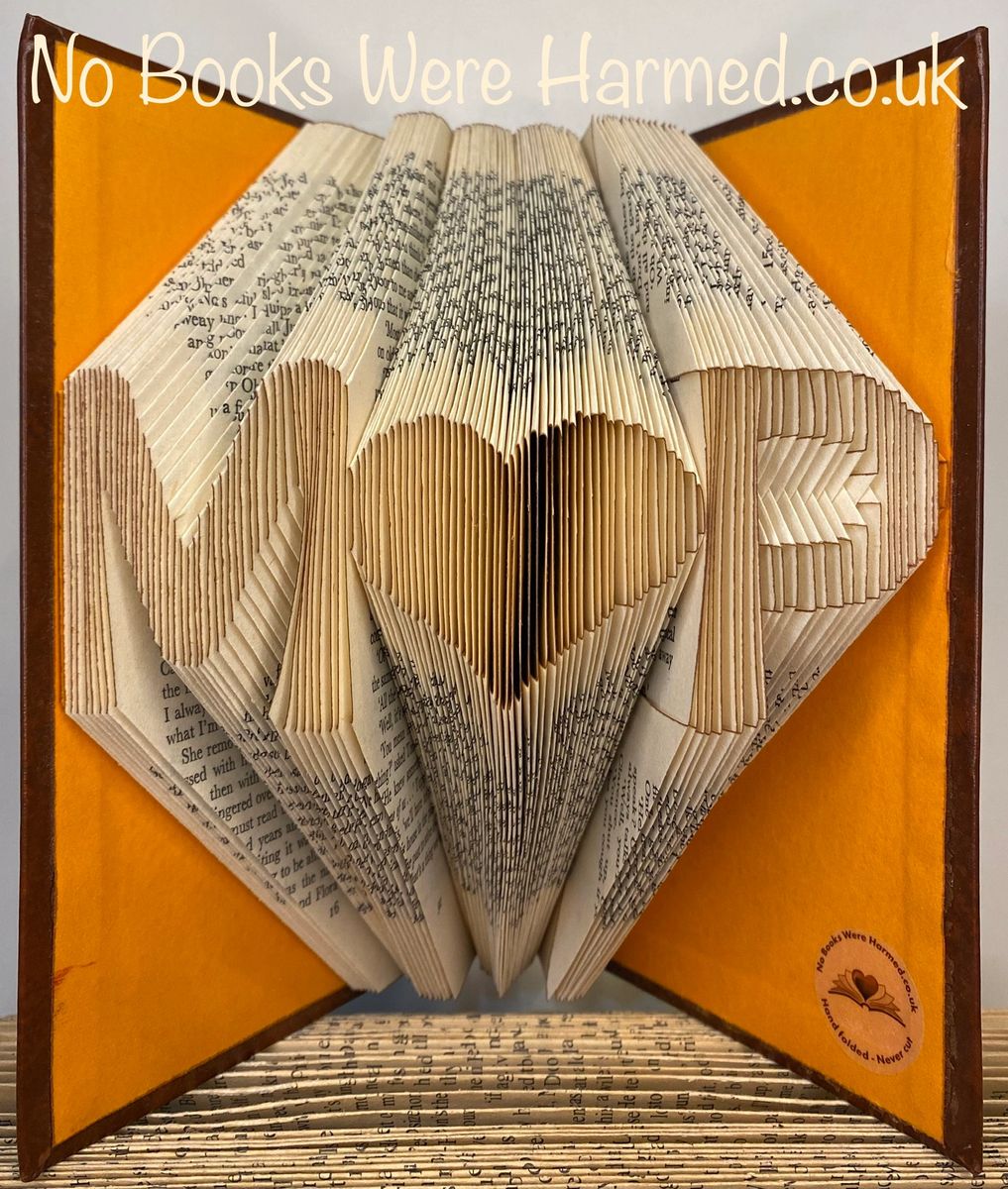 Personalized book art featuring initials beside a love heart, handcrafted from vintage pages.