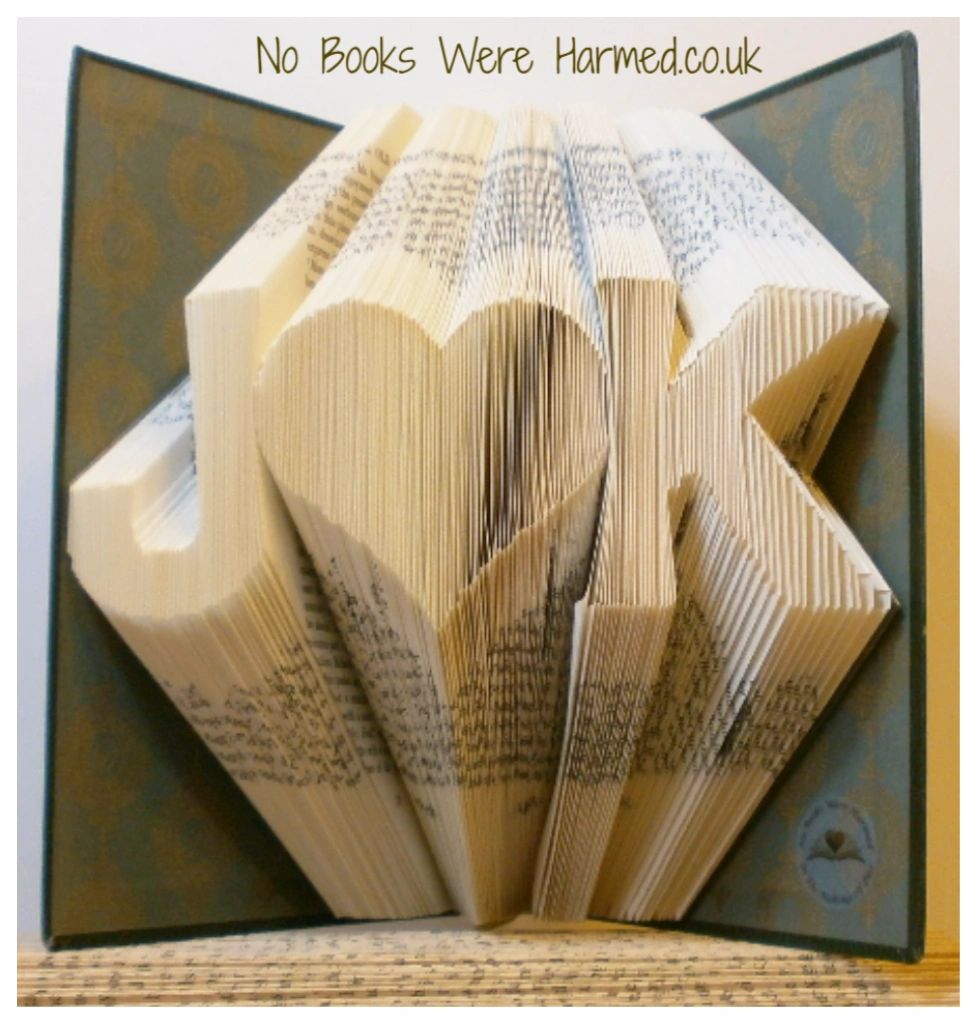 Personalized book art featuring initials beside a love heart, handcrafted from vintage pages.