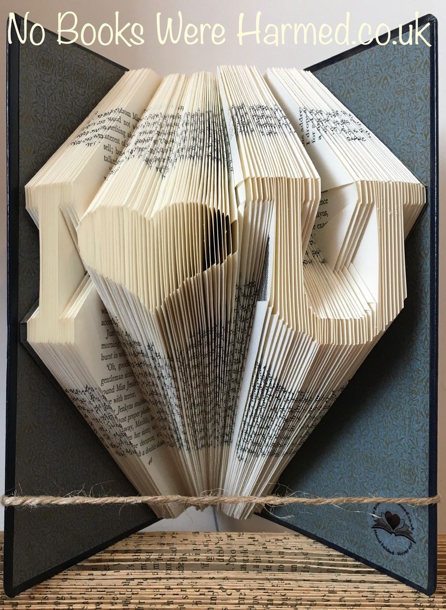 Personalized book art featuring initials beside a love heart, handcrafted from vintage pages.