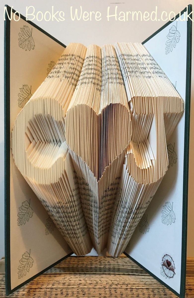 Personalized book art featuring initials beside a love heart, handcrafted from vintage pages.