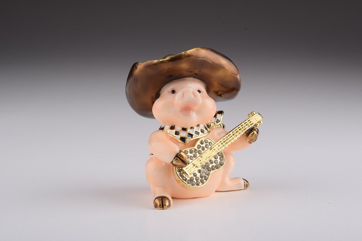 A charming enamel painted trinket box shaped like a pig playing guitar, adorned with Austrian crystals and gold plating.