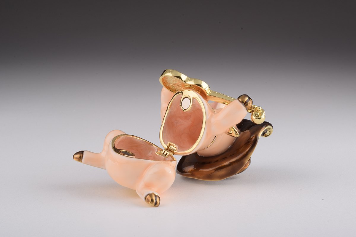 A charming enamel painted trinket box shaped like a pig playing guitar, adorned with Austrian crystals and gold plating.