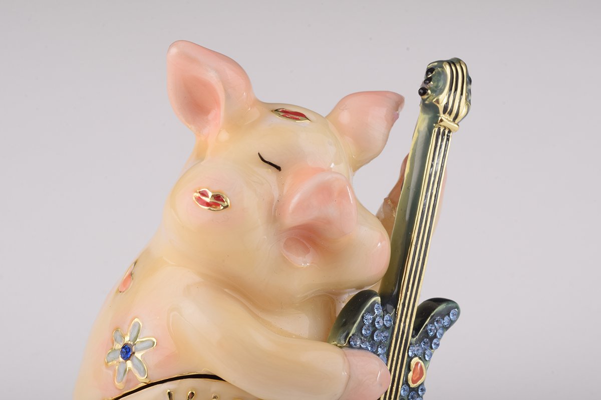 A beautifully crafted enamel trinket box featuring a pig playing guitar, adorned with sparkling Austrian crystals and plated with gold or silver.