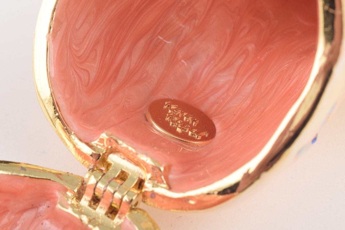 A beautifully crafted enamel trinket box featuring a pig playing guitar, adorned with sparkling Austrian crystals and plated with gold or silver.