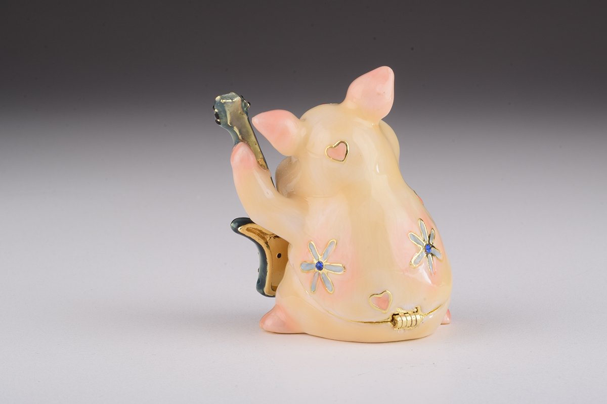 A beautifully crafted enamel trinket box featuring a pig playing guitar, adorned with sparkling Austrian crystals and plated with gold or silver.