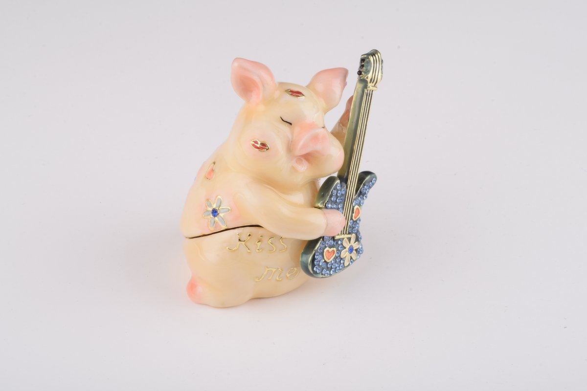 A beautifully crafted enamel trinket box featuring a pig playing guitar, adorned with sparkling Austrian crystals and plated with gold or silver.