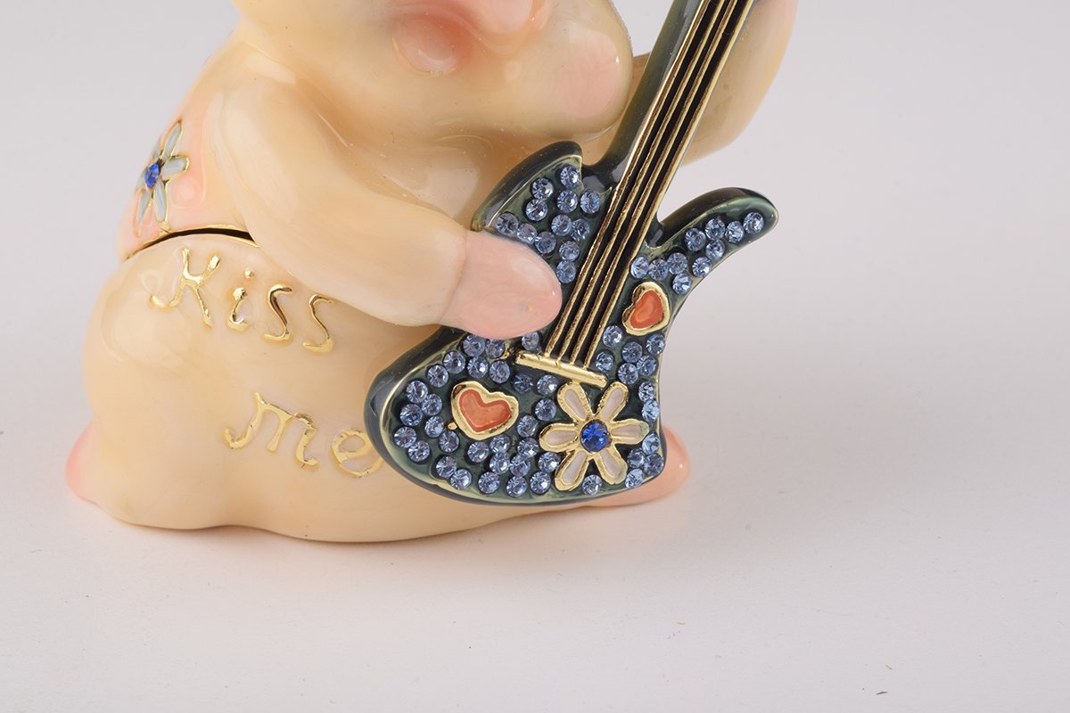 A beautifully crafted enamel trinket box featuring a pig playing guitar, adorned with sparkling Austrian crystals and plated with gold or silver.