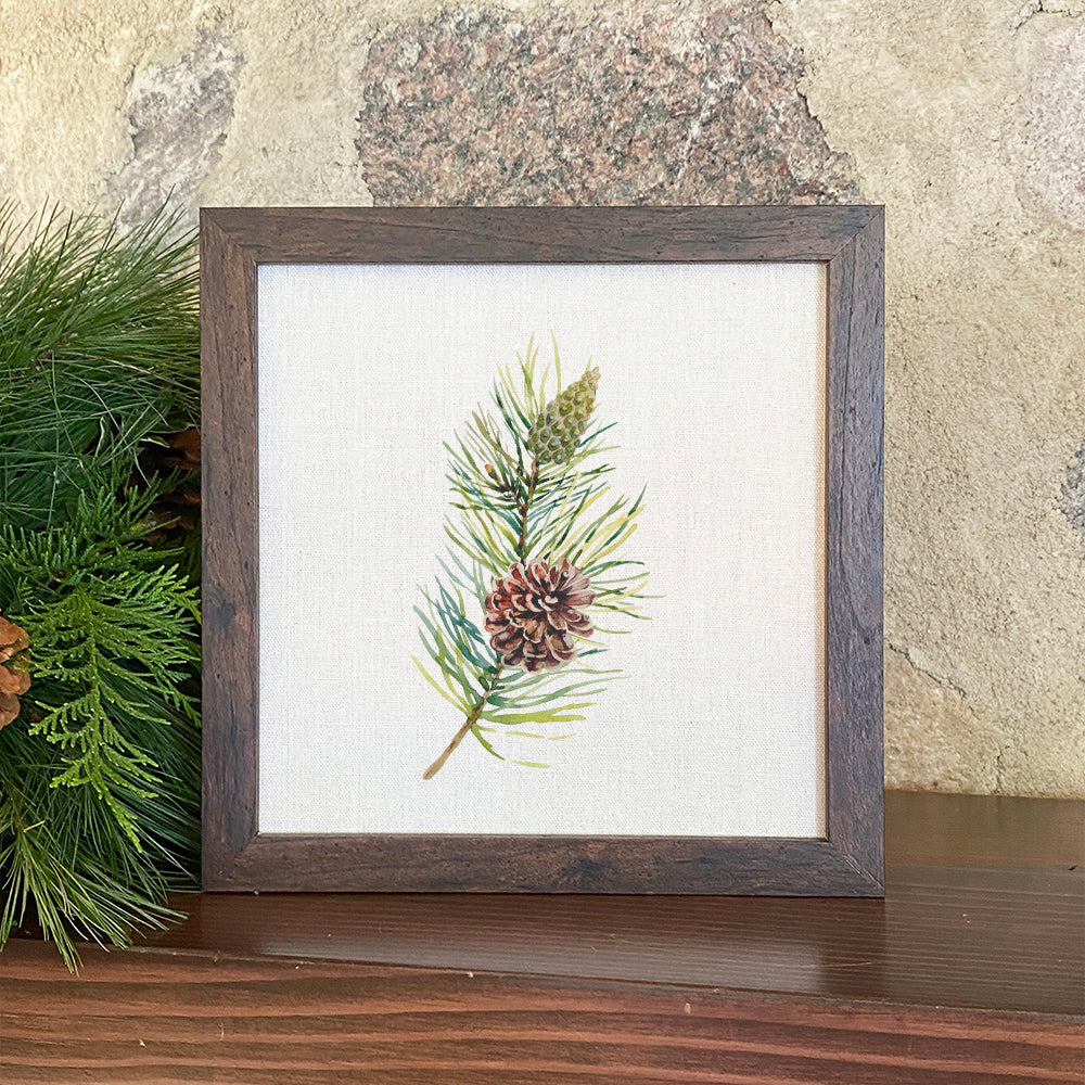 Pine Branch Framed Sign with a stylized wood frame and linen-look background, perfect for home decor.