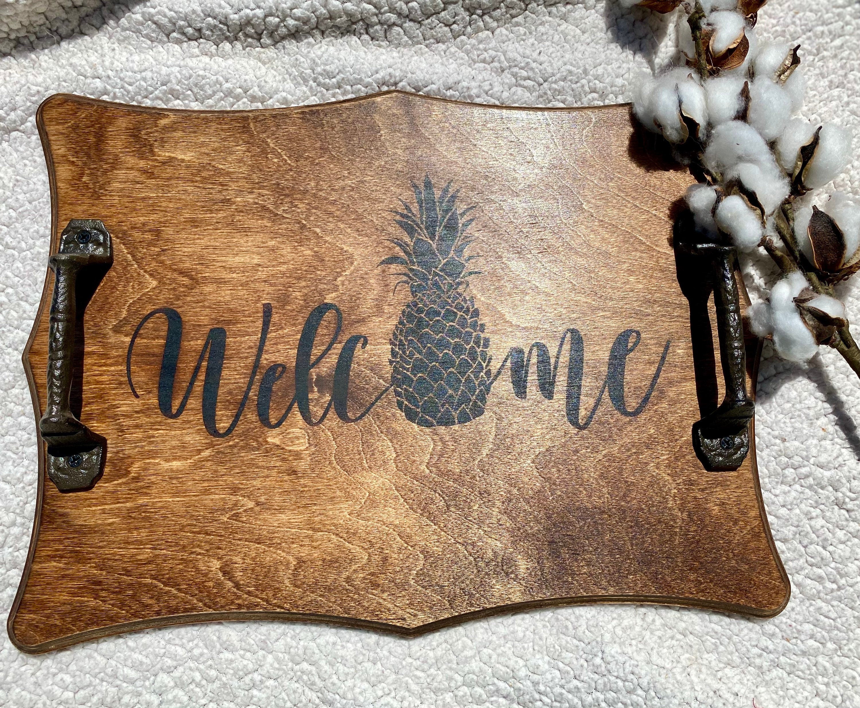 Handmade wooden Pineapple Serving Tray with rich chestnut stain and cast iron handles, perfect for kitchen decor.