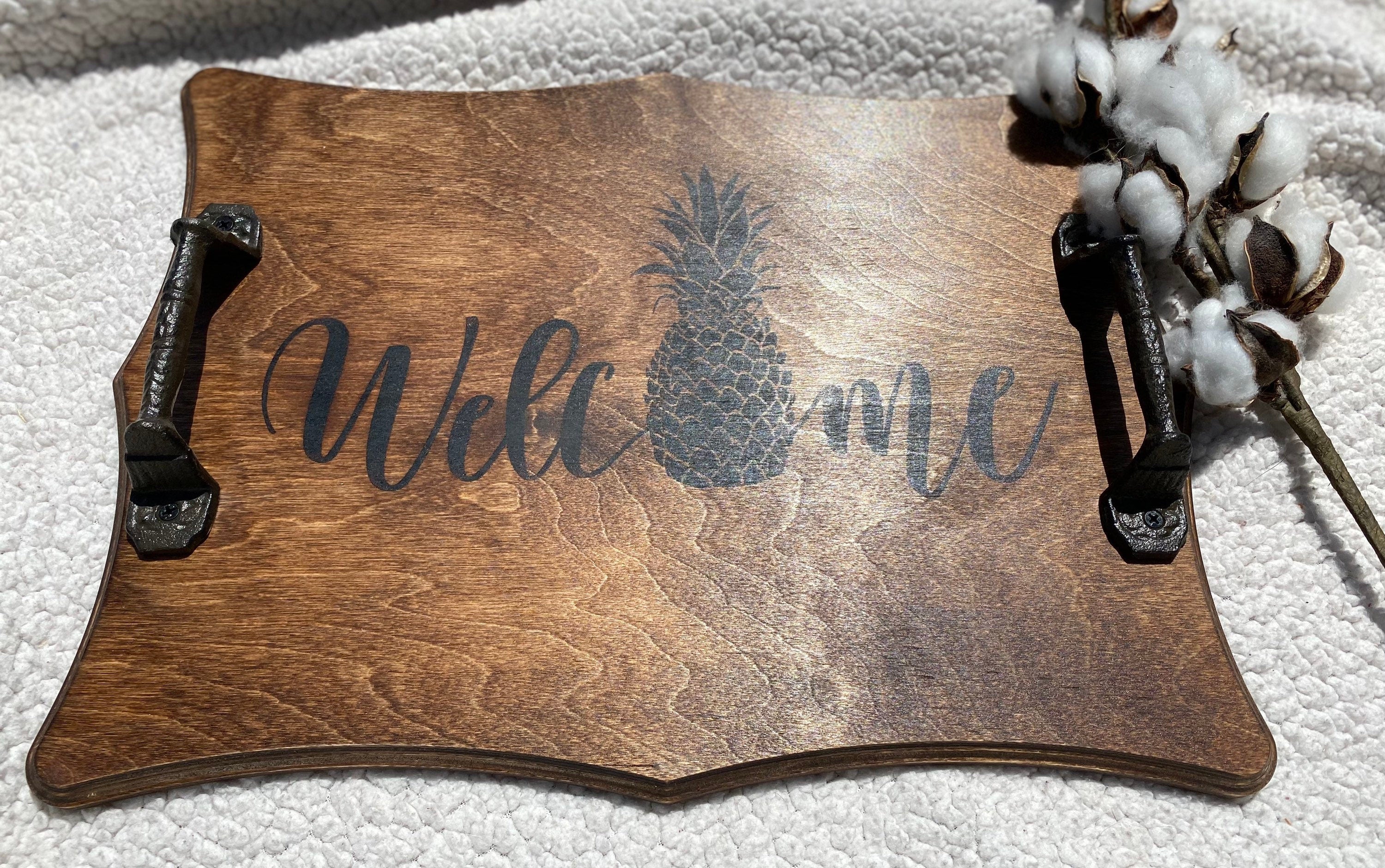 Handmade wooden Pineapple Serving Tray with rich chestnut stain and cast iron handles, perfect for kitchen decor.