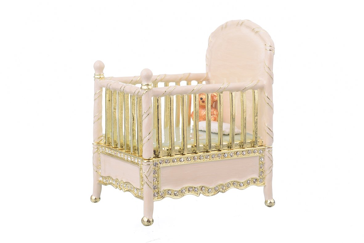 A beautifully crafted Pink Baby Bed trinket box, handmade with enamel and adorned with sparkling Austrian crystals, featuring a luxurious gold or silver plating.