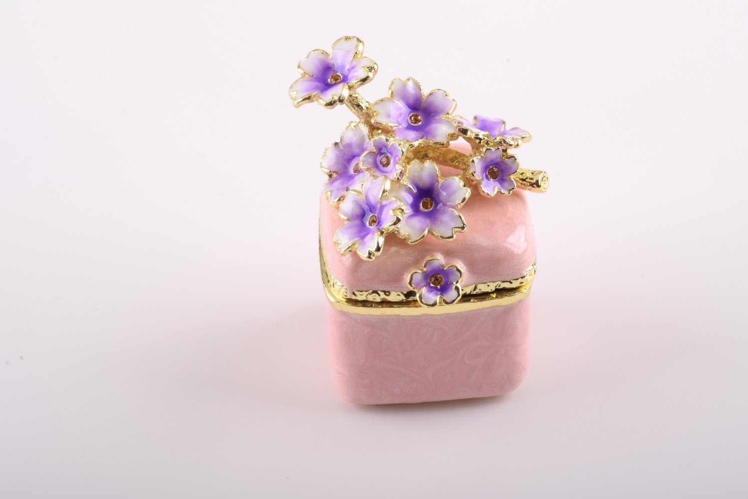 A beautiful pink enamel trinket box adorned with sparkling Austrian crystals and plated with 24K gold, showcasing exquisite craftsmanship.