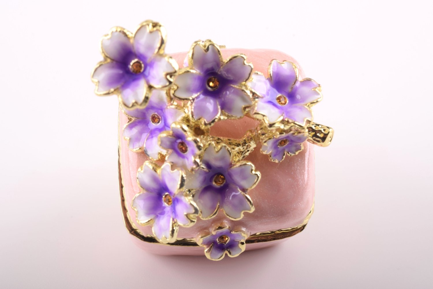 A beautiful pink enamel trinket box adorned with sparkling Austrian crystals and plated with 24K gold, showcasing exquisite craftsmanship.