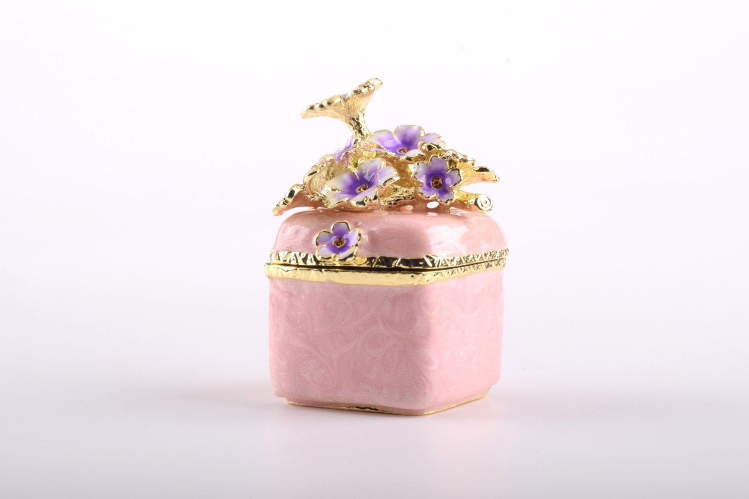 A beautiful pink enamel trinket box adorned with sparkling Austrian crystals and plated with 24K gold, showcasing exquisite craftsmanship.