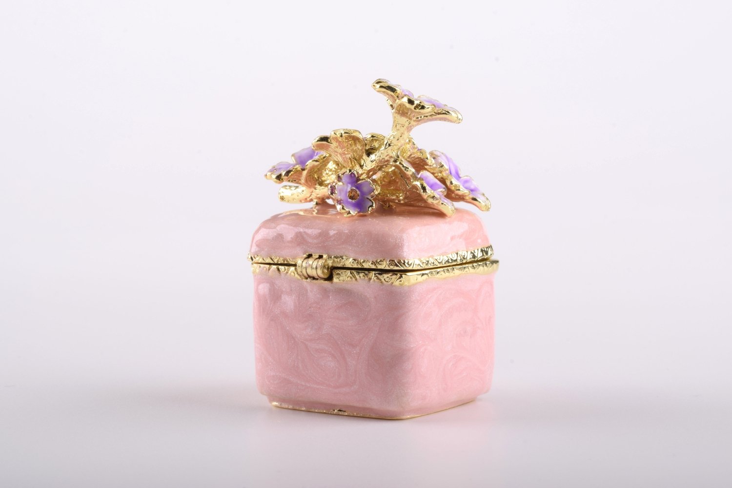 A beautiful pink enamel trinket box adorned with sparkling Austrian crystals and plated with 24K gold, showcasing exquisite craftsmanship.