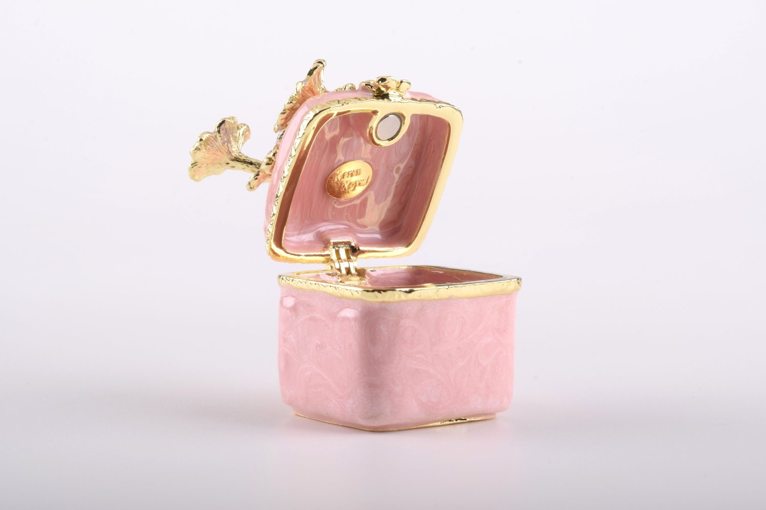 A beautiful pink enamel trinket box adorned with sparkling Austrian crystals and plated with 24K gold, showcasing exquisite craftsmanship.