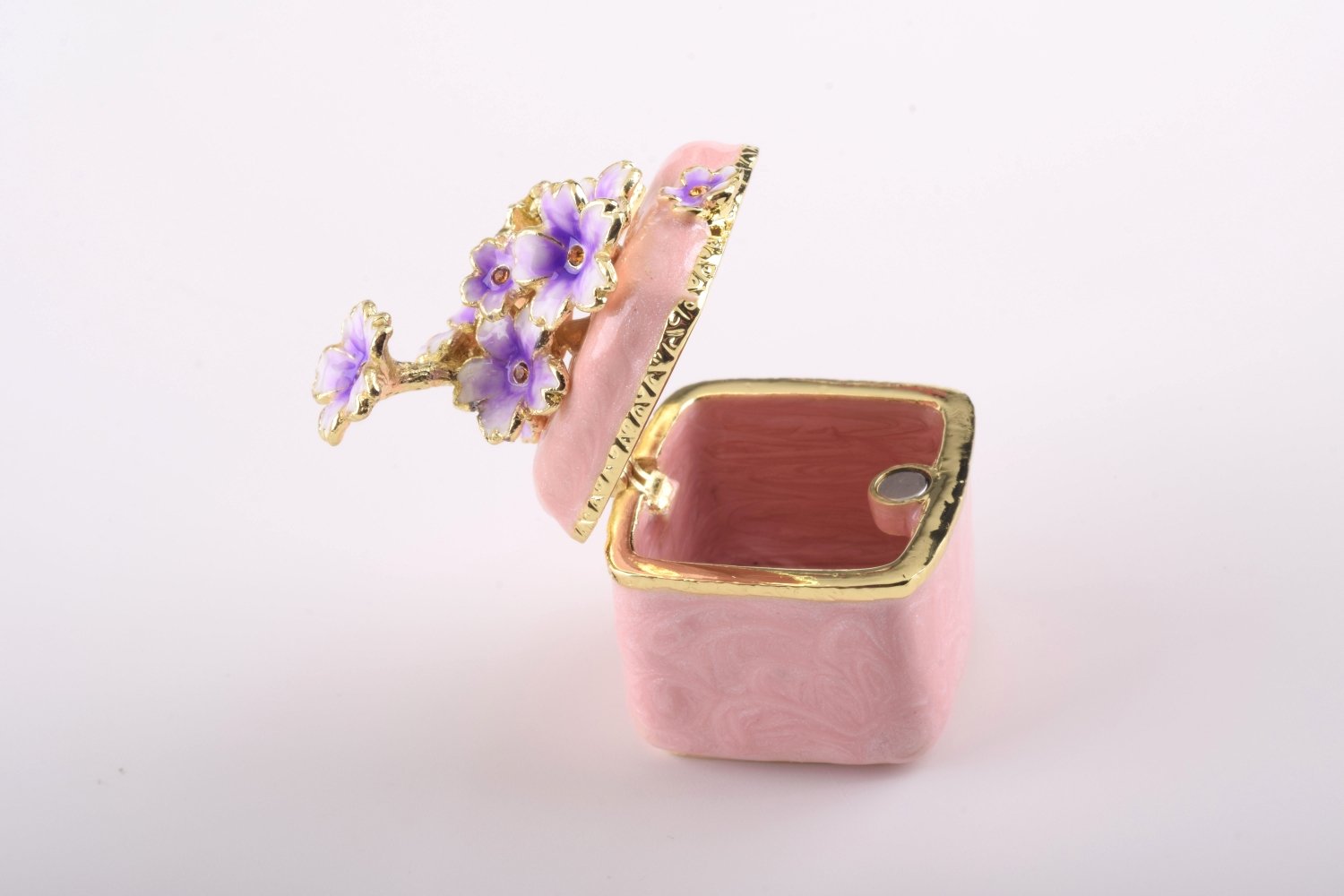 A beautiful pink enamel trinket box adorned with sparkling Austrian crystals and plated with 24K gold, showcasing exquisite craftsmanship.