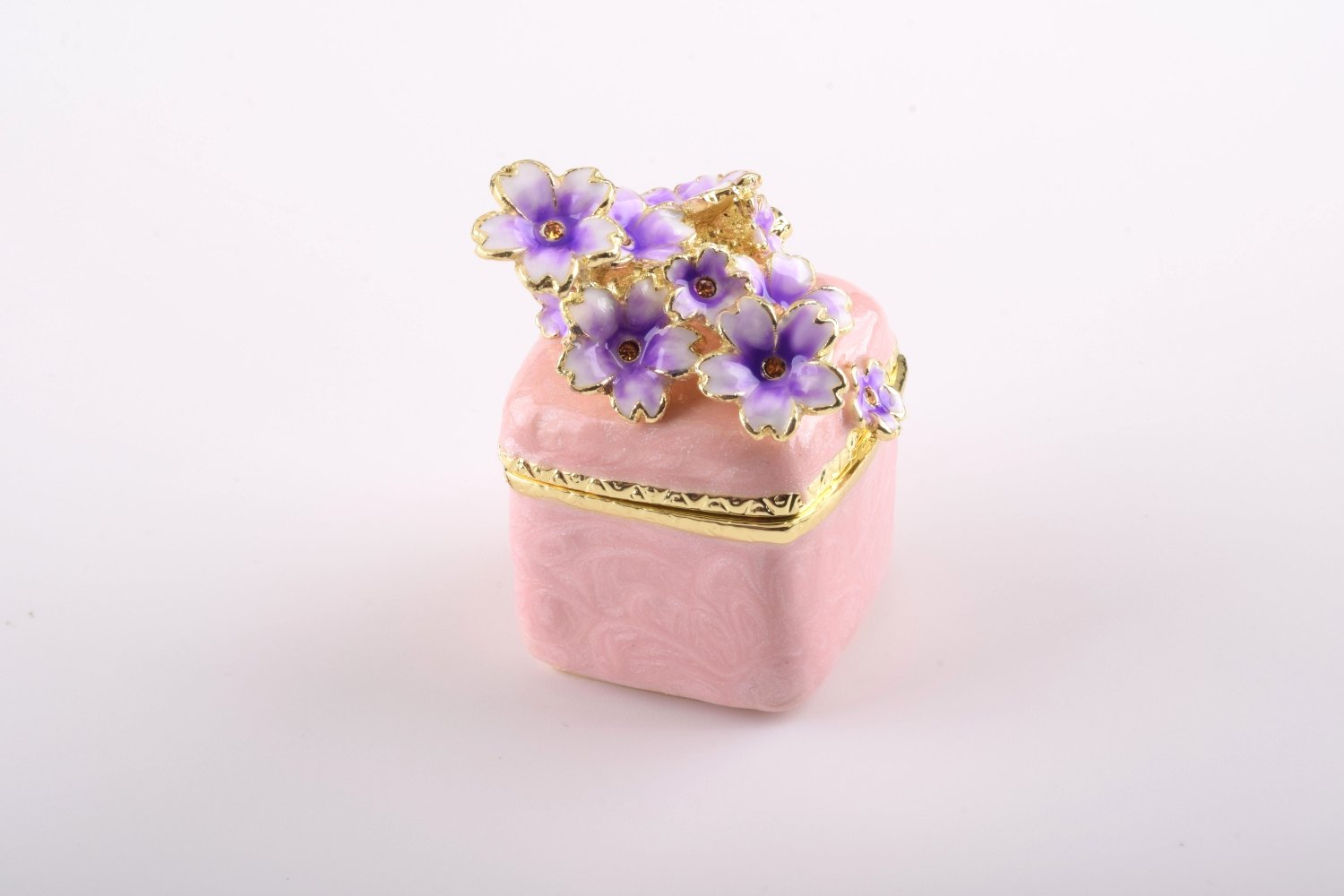 A beautiful pink enamel trinket box adorned with sparkling Austrian crystals and plated with 24K gold, showcasing exquisite craftsmanship.