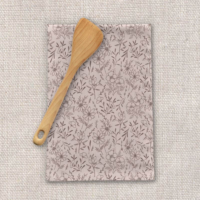 A vibrant pink flower tea towel made of cotton twill, featuring a beautiful floral design, perfect for kitchen decor.