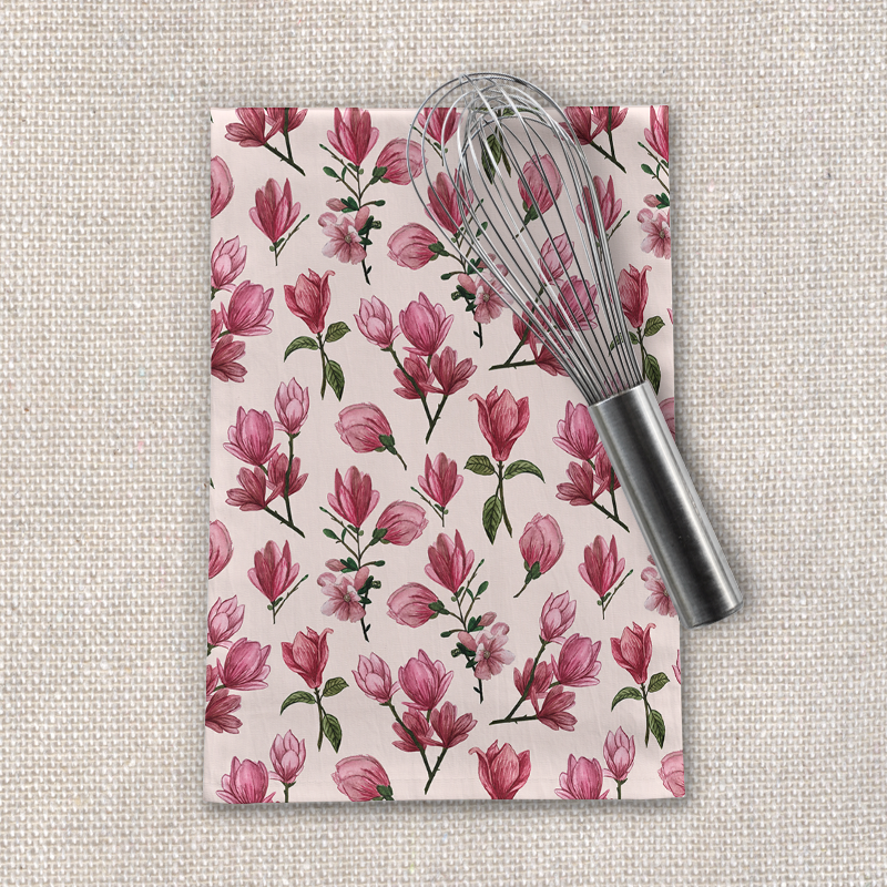 A vibrant Pink Magnolia Blossom Tea Towel featuring beautiful floral designs on a soft cotton twill fabric, perfect for kitchen decor.