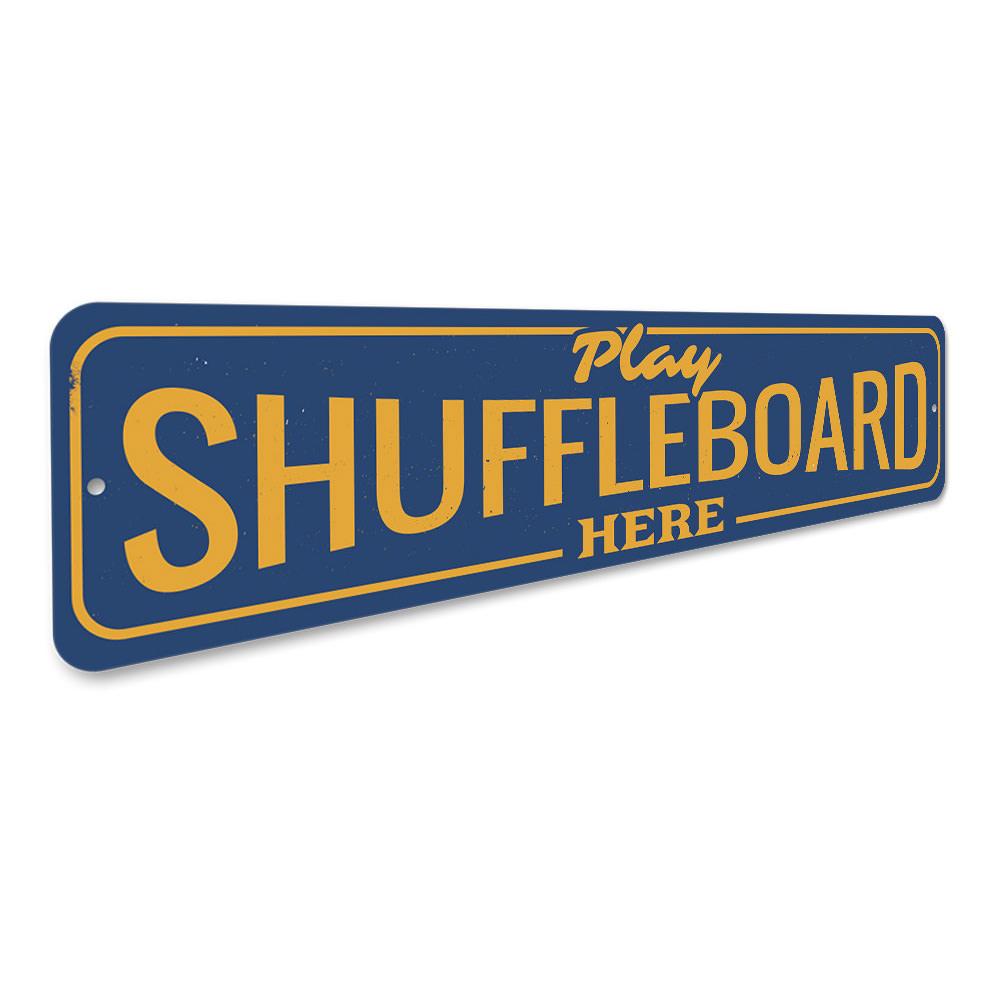 A decorative Play Shuffleboard Here Sign made of high-quality aluminum, featuring vibrant colors and customizable text, perfect for game rooms.