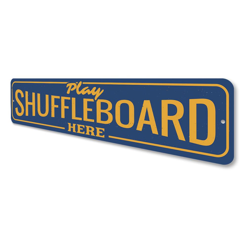 A decorative Play Shuffleboard Here Sign made of high-quality aluminum, featuring vibrant colors and customizable text, perfect for game rooms.