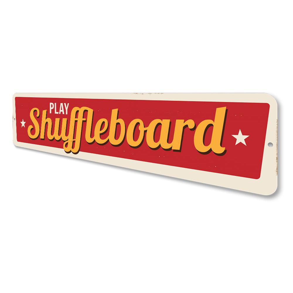 A decorative Play Shuffleboard Sign made of durable aluminum, featuring customizable text and pre-drilled holes for easy mounting.