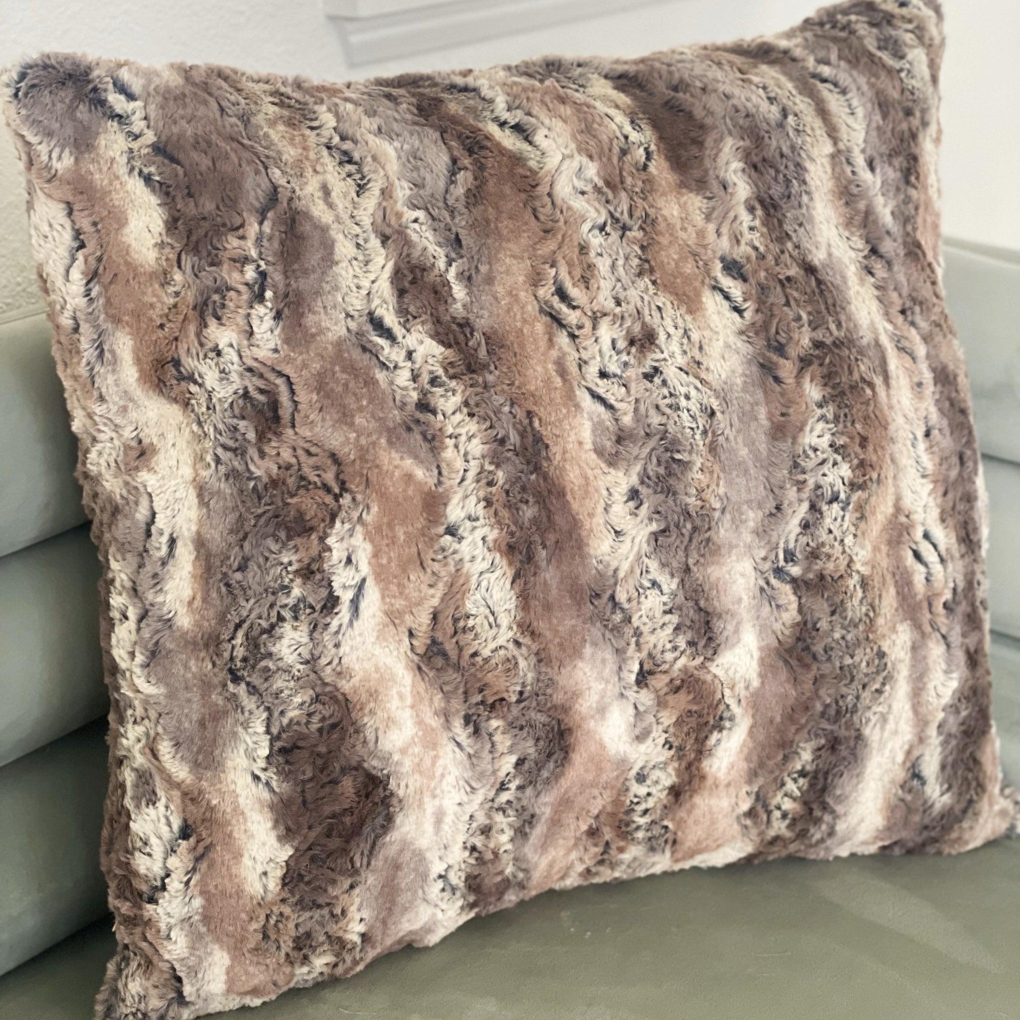 Plutus Brands Elegant Brandy Pillow in light brown, gold, and white with animal motif, showcasing its luxurious handmade design.