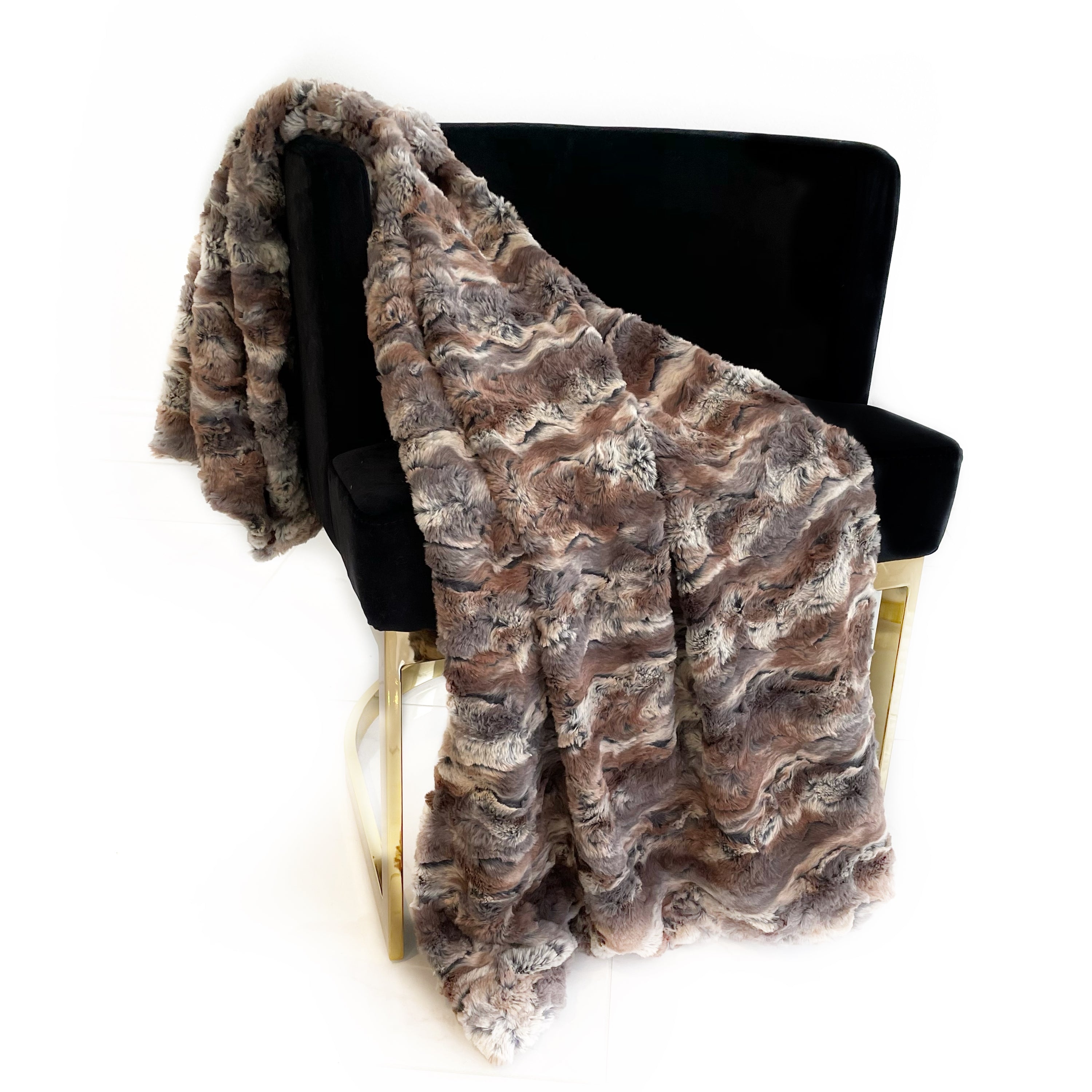 Plutus Brown Wild Rabbit Faux Fur Luxury Throw Blanket showcasing its soft texture and reversible design in a cozy living room setting.