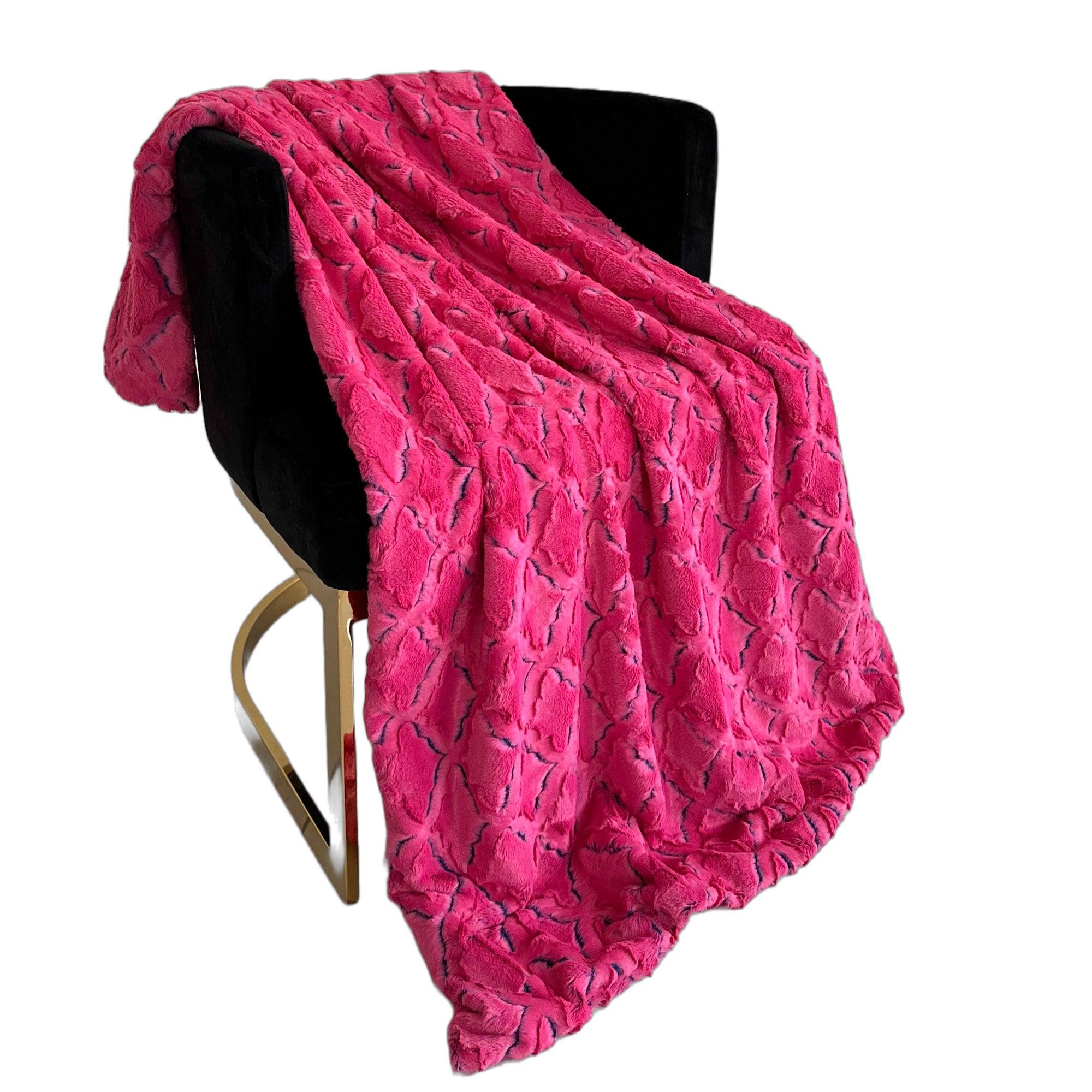 Plutus Fuchsia Purple Diamond Faux Fur Luxury Throw Blanket draped elegantly on a couch, showcasing its vibrant color and plush texture.