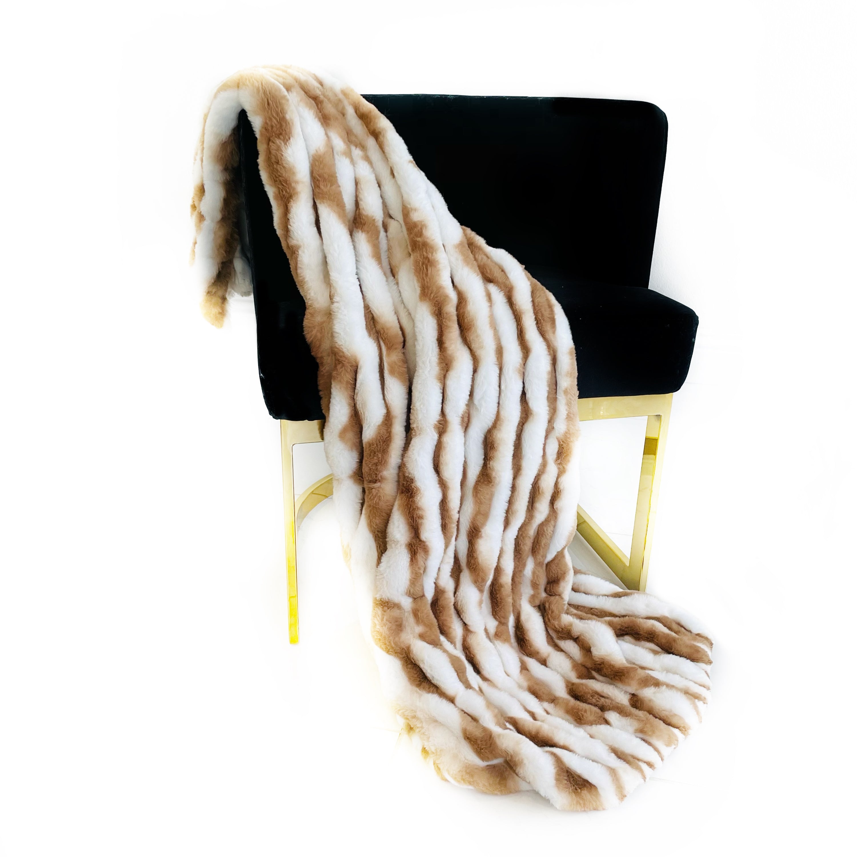 Plutus White Taupe Snow Chinchilla Faux Fur Luxury Throw Blanket draped elegantly over a sofa, showcasing its soft texture and stylish color.