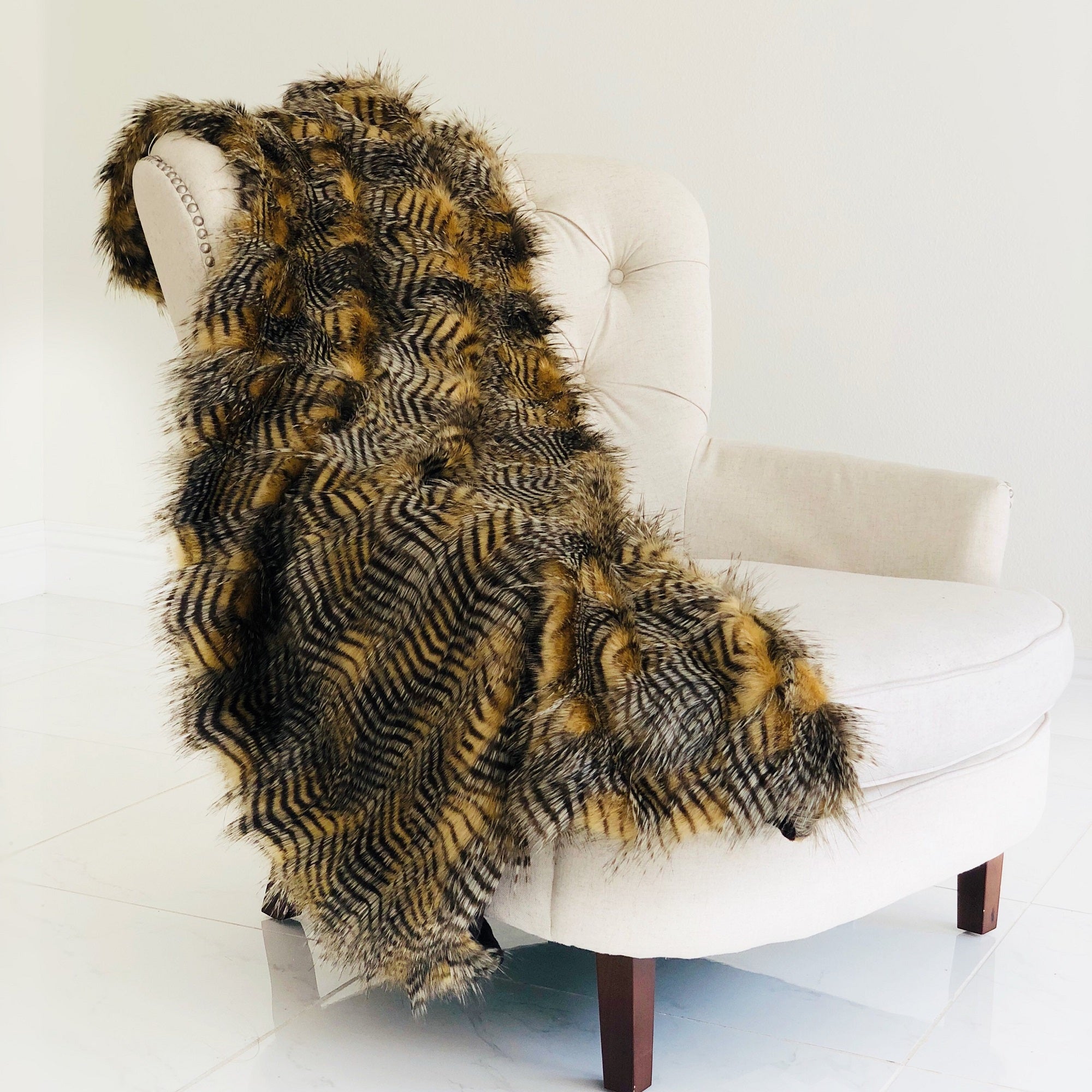 Porcupine Mocha Faux Fur Luxury Throw showcasing rich brown and grey tones, draped elegantly on a sofa.