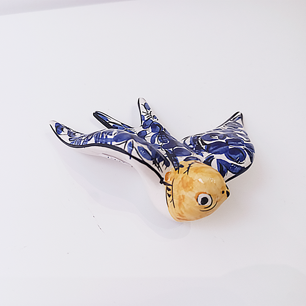 A beautifully hand-painted Portuguese Ceramic Swallow from the 19th century, showcasing intricate details and vibrant colors, symbolizing love and hope.