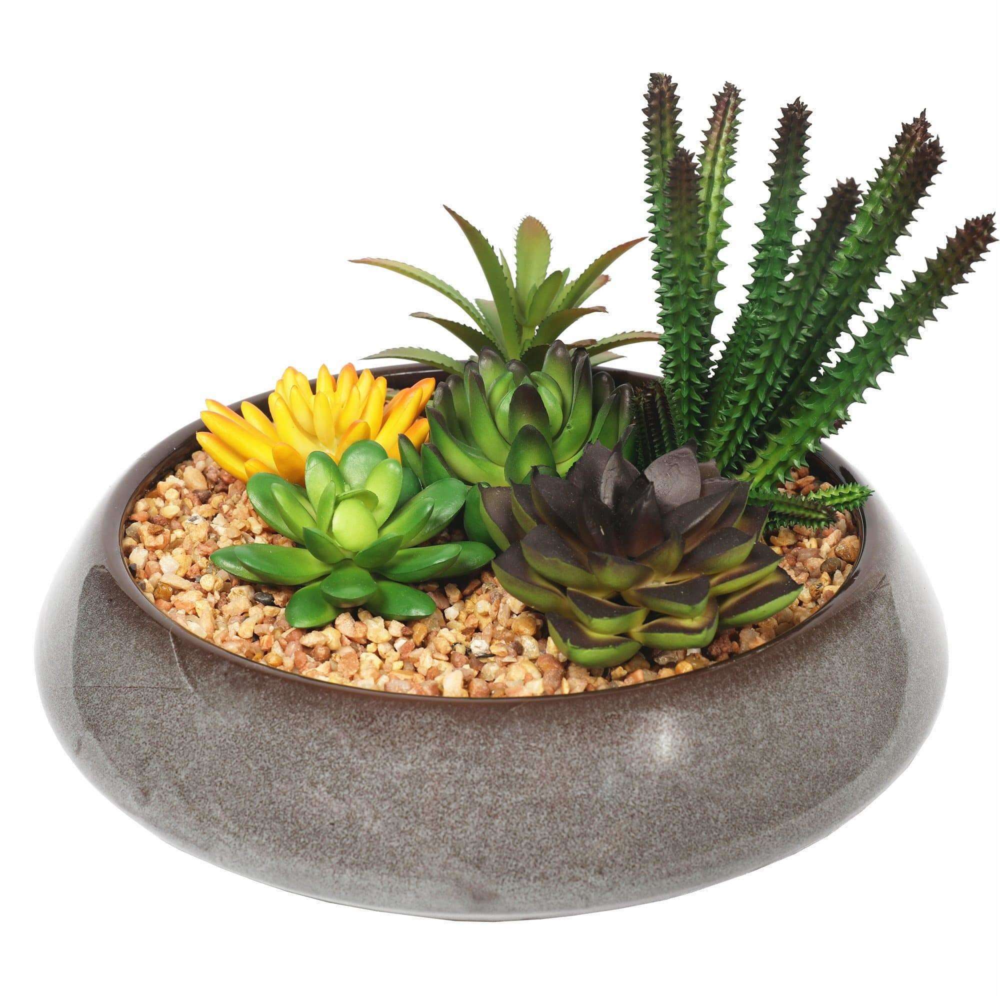 A beautifully arranged potted artificial succulent in a modern round decorative bowl, featuring realistic green succulents and decorative pebbles.