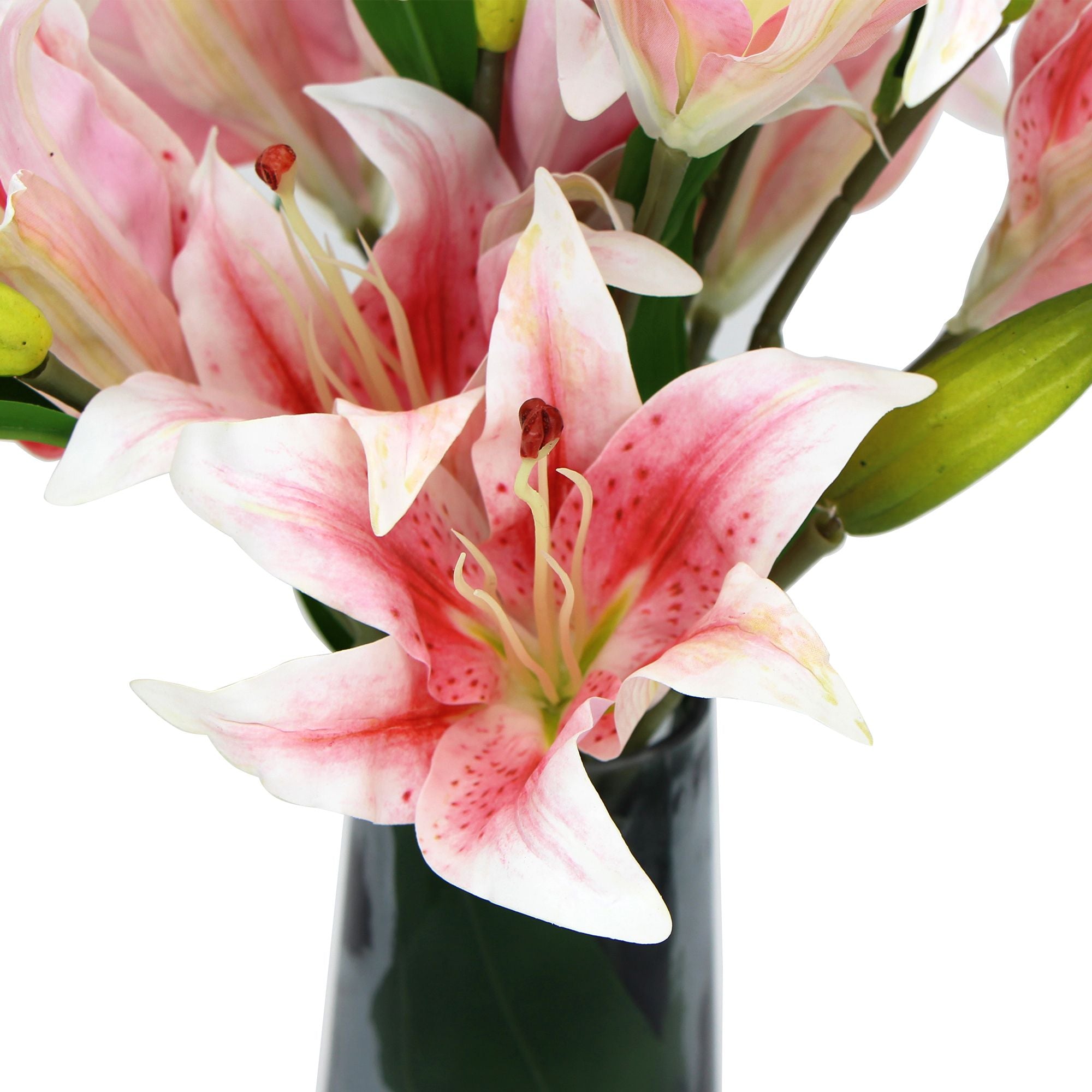 A beautiful arrangement of premium faux pink lilies in a clear glass vase, showcasing realistic flowers and foliage.