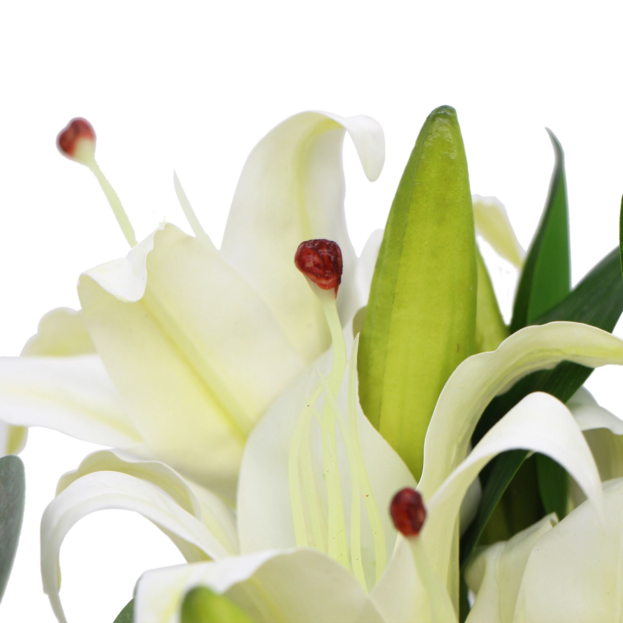 A beautiful arrangement of premium faux white lilies in a stylish glass vase, showcasing realistic petals and lush eucalyptus stems.