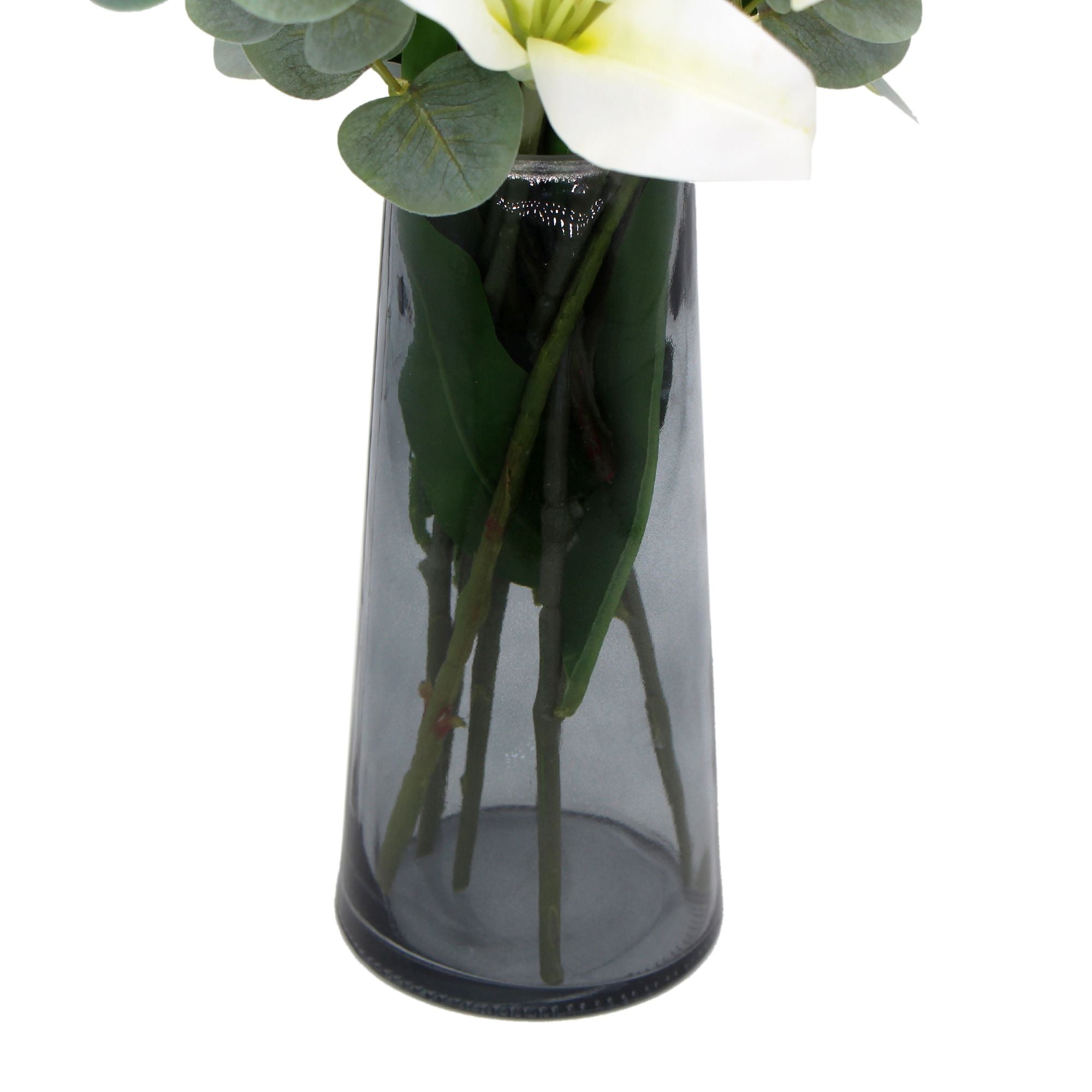 A beautiful arrangement of premium faux white lilies in a stylish glass vase, showcasing realistic petals and lush eucalyptus stems.