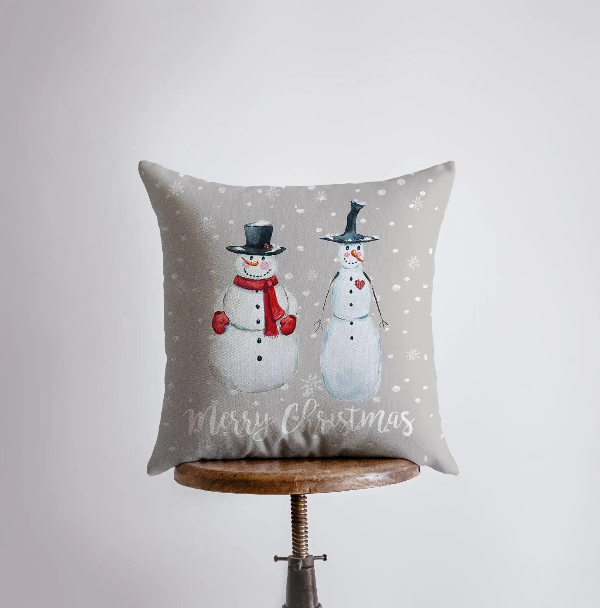 Primitive Snowmen Throw Pillow Cover featuring two snowmen in top hats on a tan gray background, perfect for rustic Christmas decor.